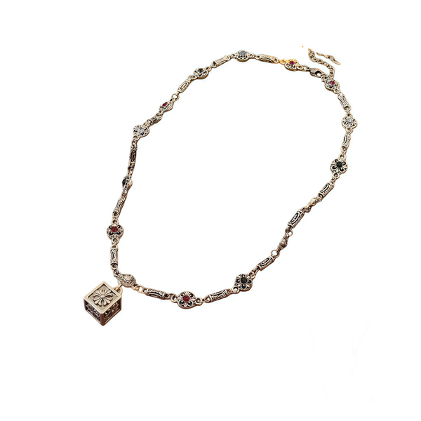 Square-Shaped Pendant With Diamonds and A Circular Flower Design.