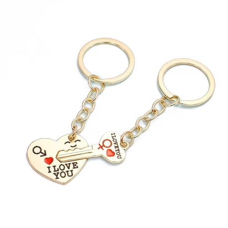 A Set Of Two Golden Heart-Shaped Keychains For Couple Image