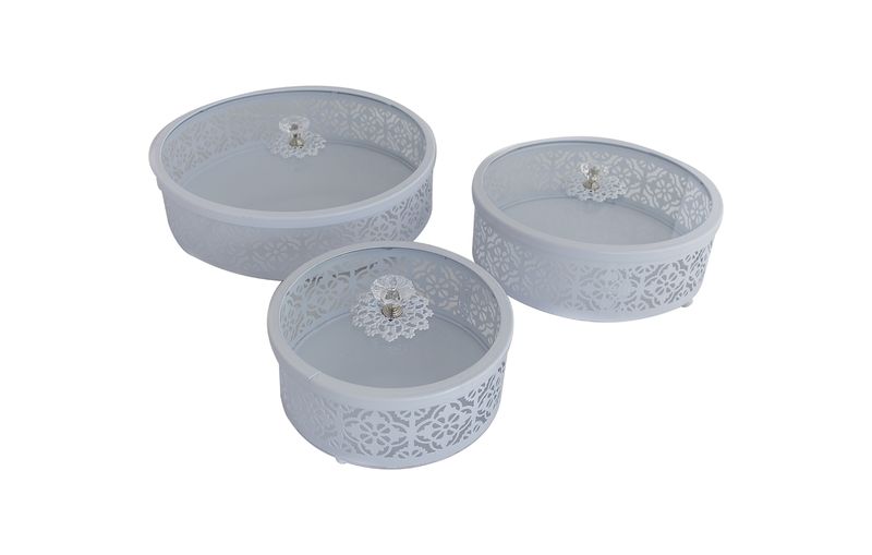 Set of three white round metal trays with glass lids