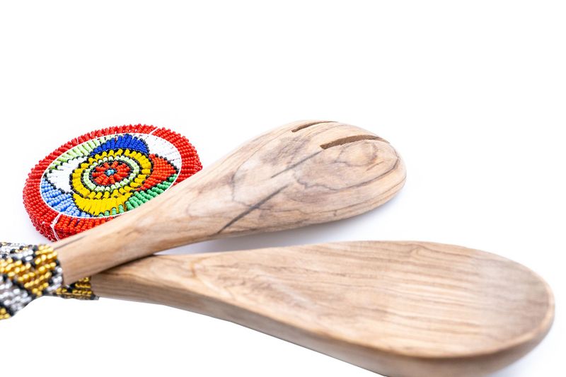 Multicoloured coaster and wooden salad spoon set